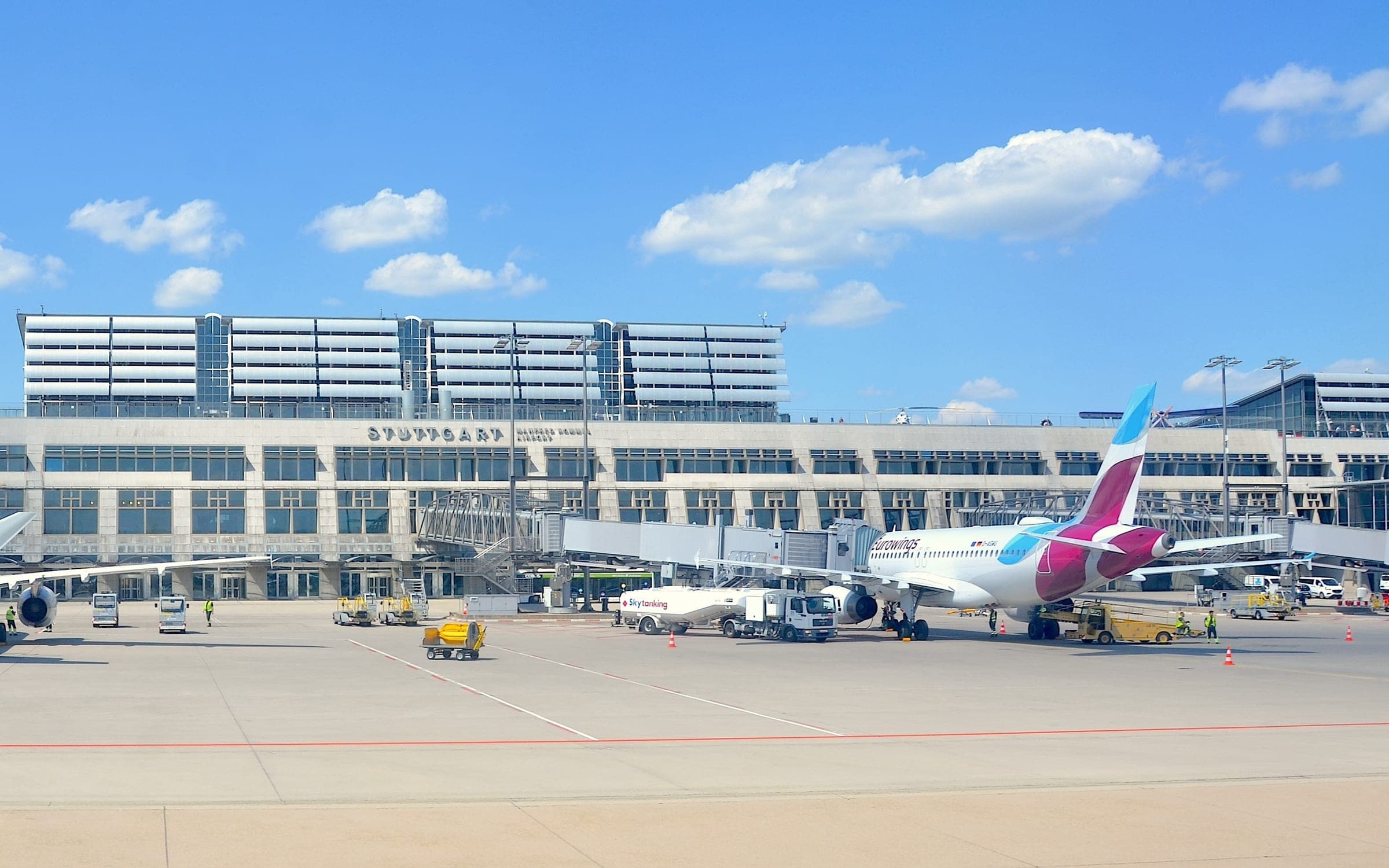 Terminalgebäude des Flughafens Stuttgart vom Vorfeld aus gesehen, mit Flugzeug an der Fluggastbrücke